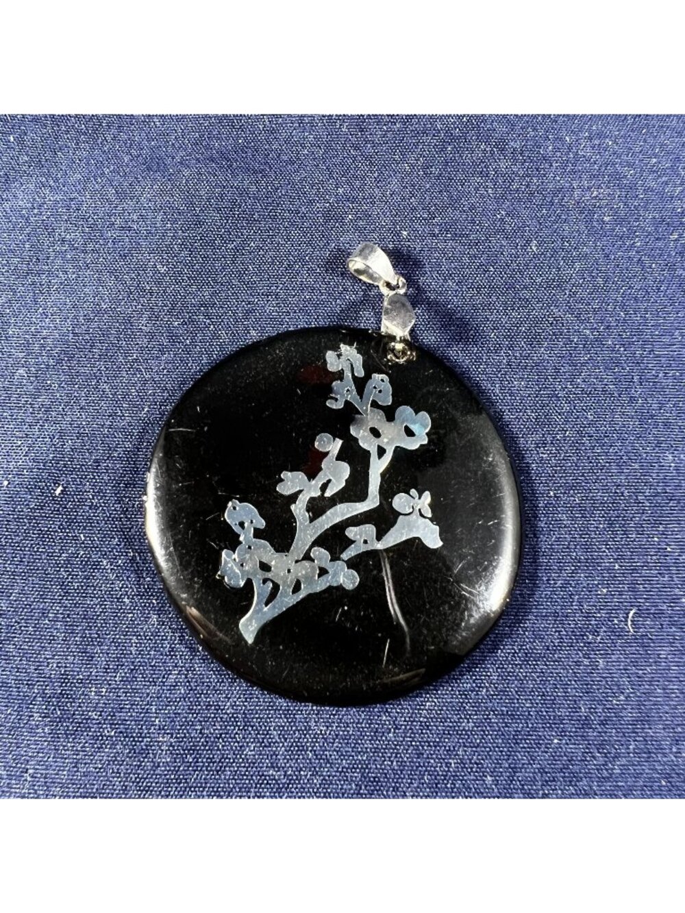 Black Round Pendant With Silver Floral Design